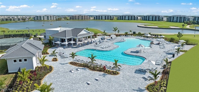 pool with a water view and a patio