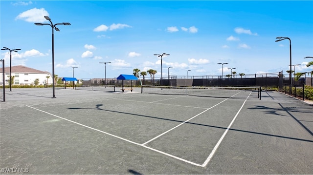 view of tennis court with fence
