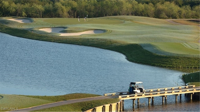 view of property's community featuring a water view, a boat dock, and view of golf course