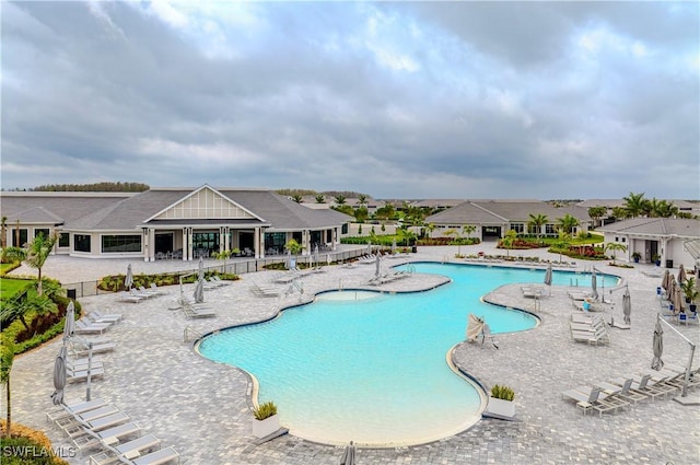 pool featuring a patio and fence