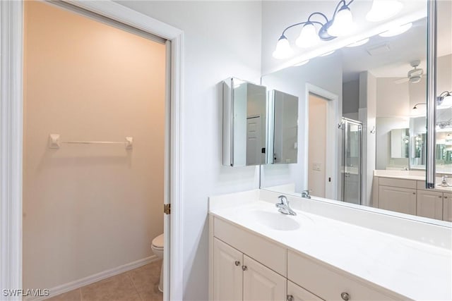 bathroom featuring toilet, a shower stall, tile patterned flooring, ceiling fan, and vanity