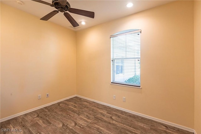 spare room with dark wood finished floors, recessed lighting, a ceiling fan, and baseboards