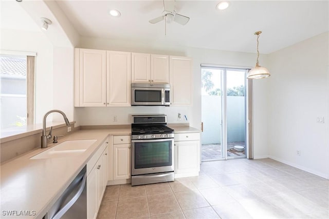 kitchen featuring light countertops, recessed lighting, stainless steel appliances, white cabinetry, and a sink