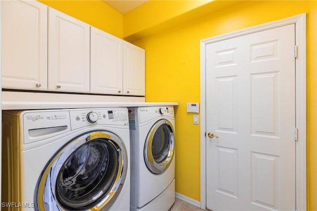 laundry area with cabinet space, independent washer and dryer, and baseboards