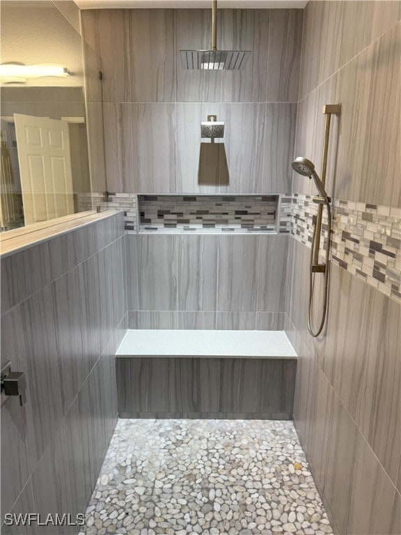 bathroom with a tile shower