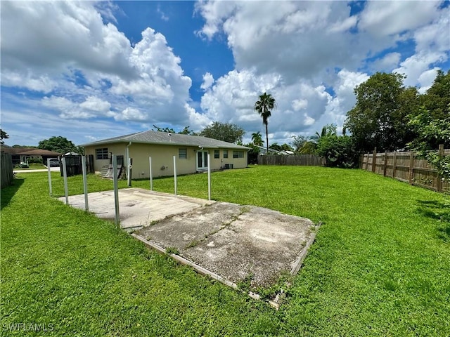 view of yard with a patio, a fenced backyard, and driveway