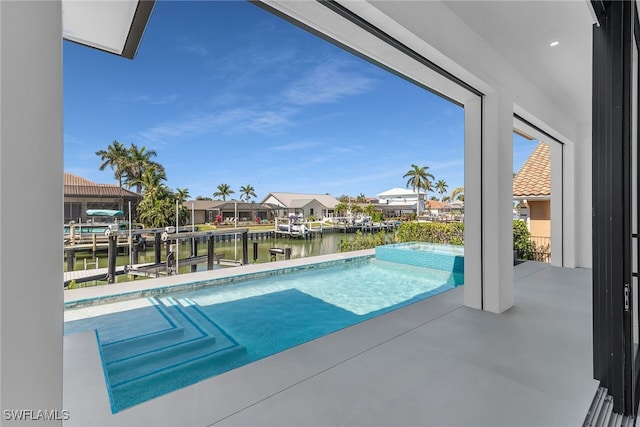 view of swimming pool with a patio, a residential view, a water view, a dock, and a pool with connected hot tub