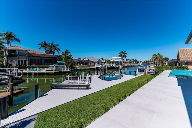 view of dock with a lawn, a water view, and boat lift