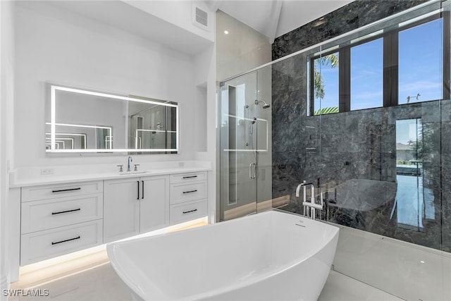 full bath with a freestanding tub, a shower stall, visible vents, and vanity