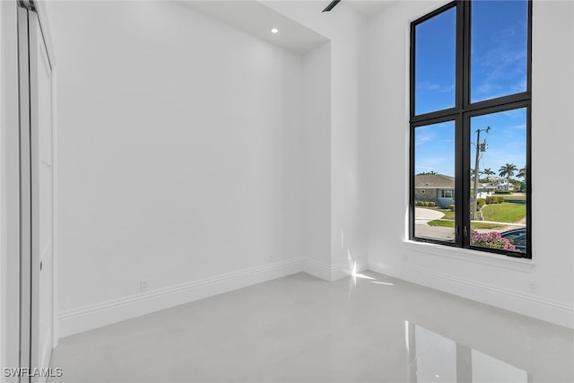 unfurnished room featuring recessed lighting and baseboards