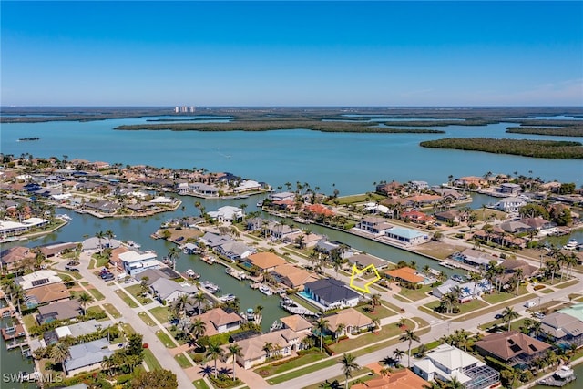 drone / aerial view with a water view and a residential view