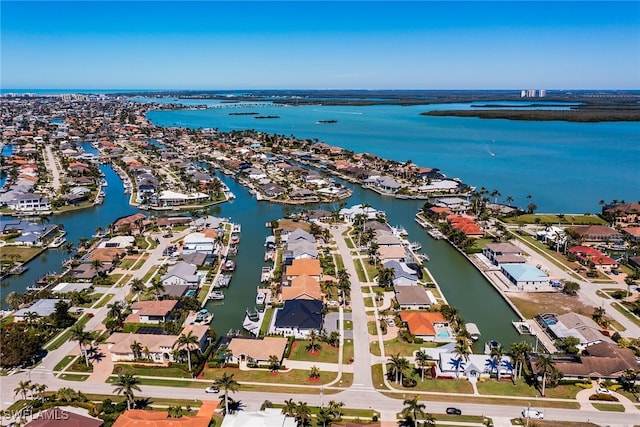 drone / aerial view with a water view and a residential view