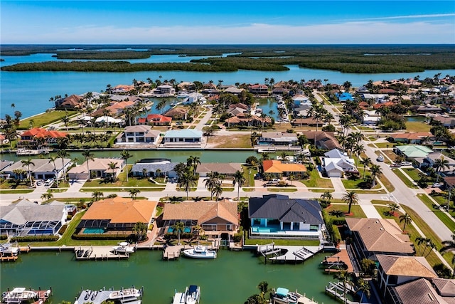 drone / aerial view with a water view and a residential view