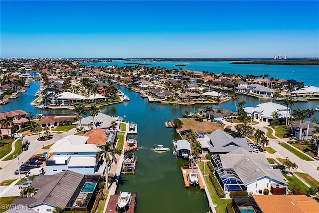 drone / aerial view featuring a water view and a residential view