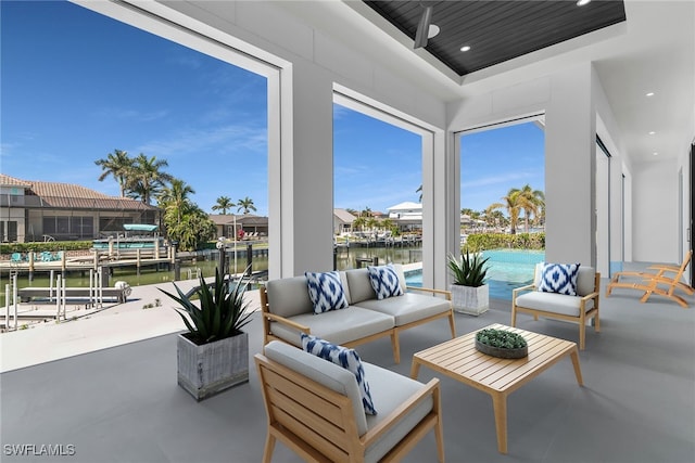 view of patio with a water view and an outdoor living space