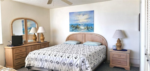 carpeted bedroom with ceiling fan and a textured ceiling