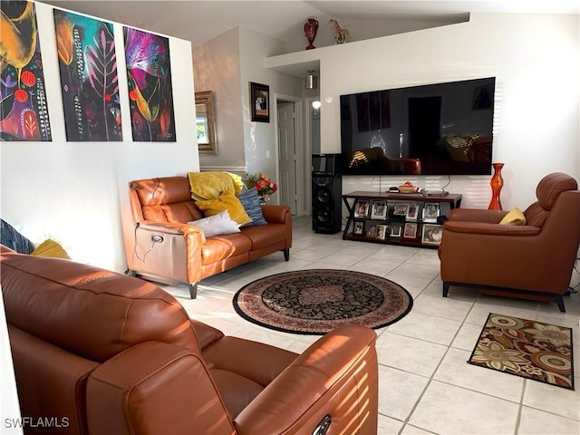 living room featuring lofted ceiling and tile patterned flooring