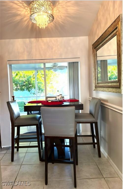 dining space with a chandelier, a healthy amount of sunlight, and light tile patterned floors