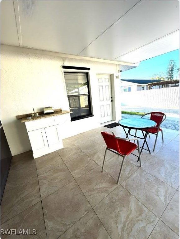 view of patio / terrace featuring fence