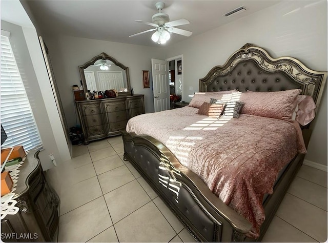 bedroom featuring visible vents, a ceiling fan, and light tile patterned flooring