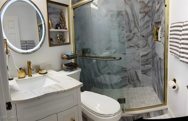 bathroom featuring vanity, a marble finish shower, and toilet