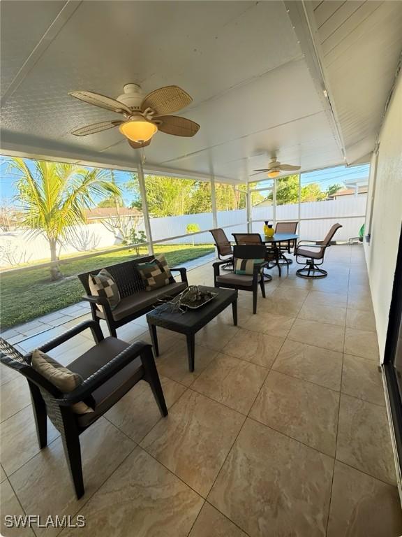 sunroom featuring a ceiling fan