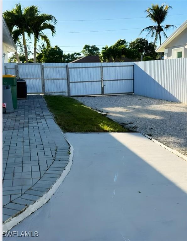 view of yard with a patio area, a gate, and fence