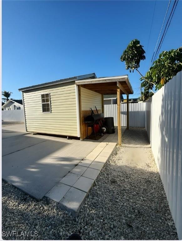 view of property exterior with a fenced backyard and a patio