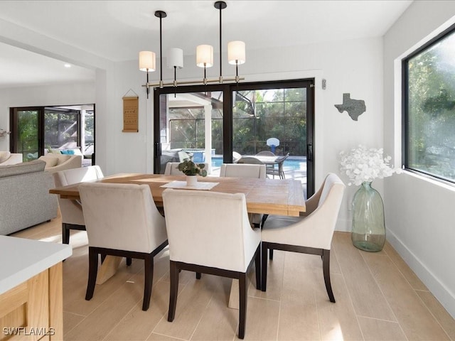 dining area with a notable chandelier and baseboards