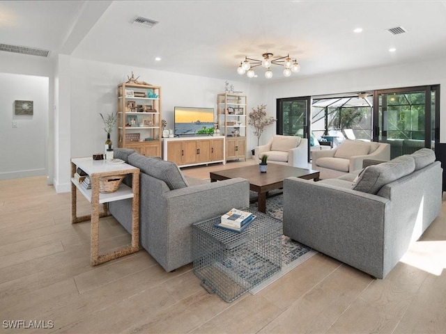 living room with light wood-type flooring, visible vents, and recessed lighting