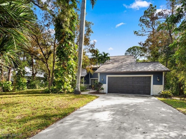 view of front of home featuring a garage, concrete driveway, and a front lawn