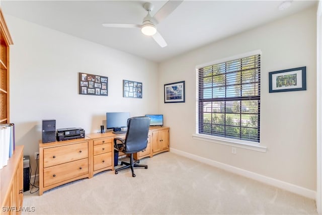 office with light carpet, a ceiling fan, and baseboards