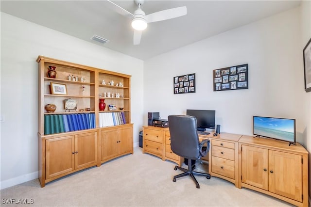 home office with visible vents, light carpet, baseboards, and ceiling fan