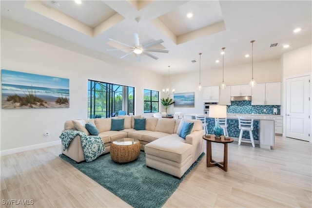 living room with visible vents, ceiling fan with notable chandelier, coffered ceiling, a high ceiling, and baseboards