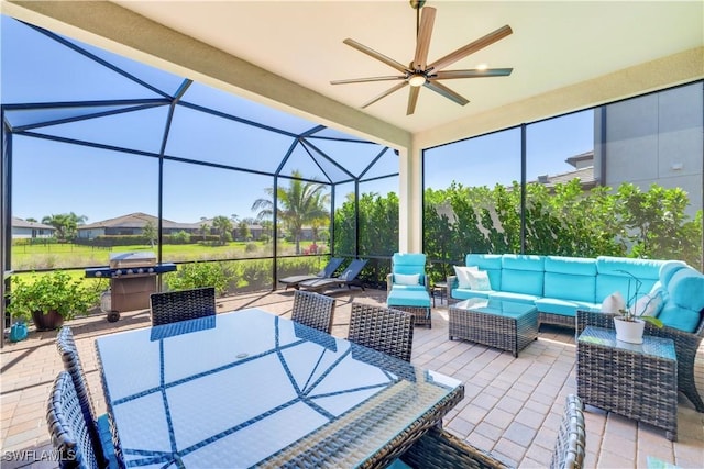 view of patio with ceiling fan, area for grilling, a lanai, and outdoor lounge area