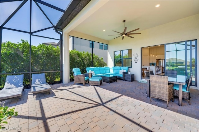 view of patio / terrace with a lanai, an outdoor living space, outdoor dining area, and a ceiling fan