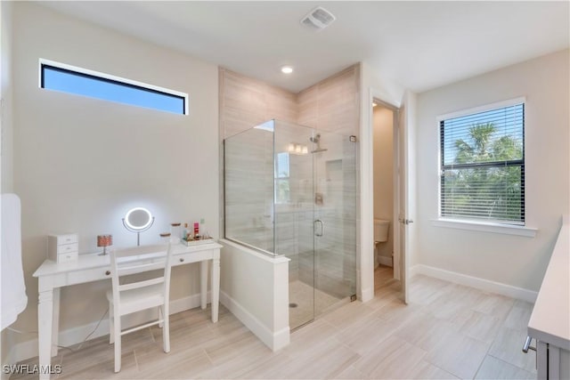 full bath featuring visible vents, a shower stall, toilet, and baseboards