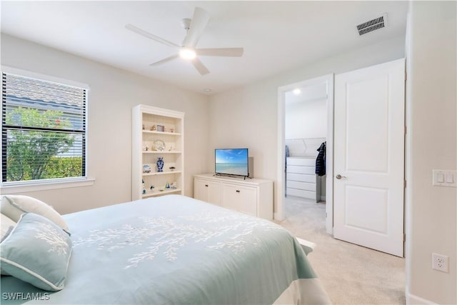 bedroom featuring visible vents, light colored carpet, and a ceiling fan