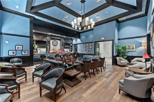 interior space with an inviting chandelier, wood finished floors, visible vents, and coffered ceiling