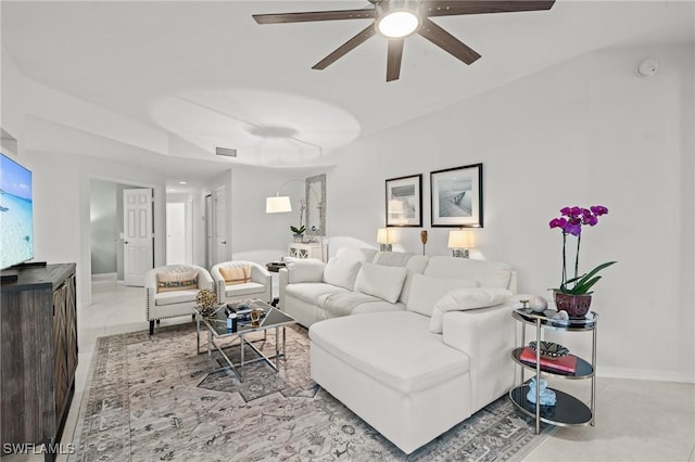 living area featuring a ceiling fan, visible vents, and baseboards