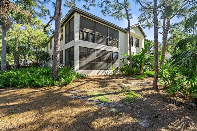 rear view of property featuring a sunroom