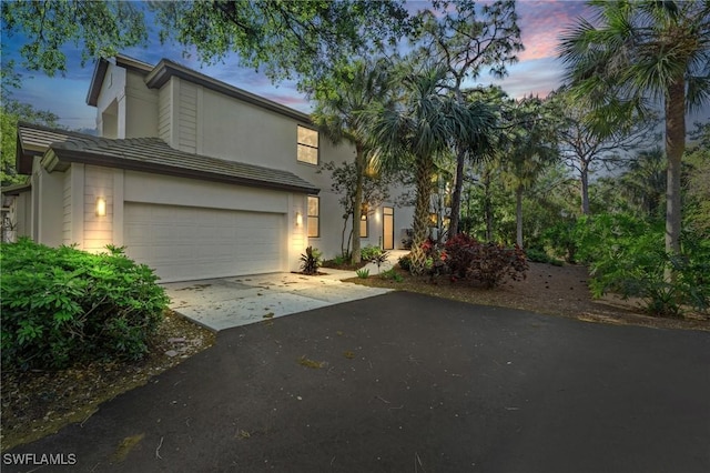 view of front of home featuring concrete driveway and an attached garage