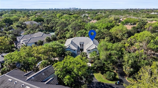 drone / aerial view featuring a view of trees