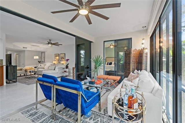 living area featuring visible vents and light tile patterned flooring