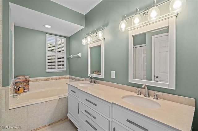 full bath with a sink, a garden tub, double vanity, and tile patterned floors