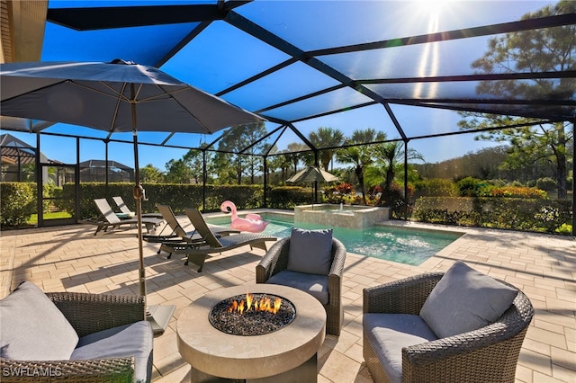 view of patio / terrace with an outdoor fire pit, glass enclosure, and a pool with connected hot tub