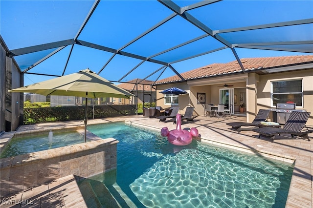 view of pool with a pool with connected hot tub, ceiling fan, a lanai, outdoor dining space, and a patio