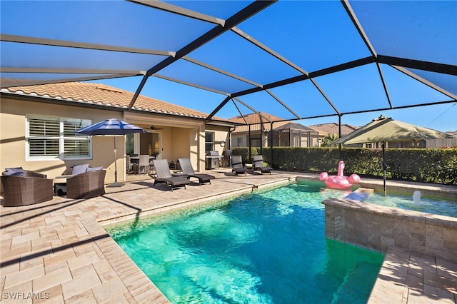 view of swimming pool with an outdoor living space, a pool with connected hot tub, ceiling fan, glass enclosure, and a patio