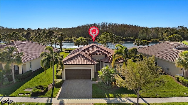 bird's eye view with a wooded view and a water view