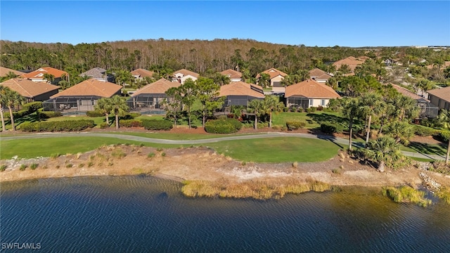 drone / aerial view with a water view and a residential view